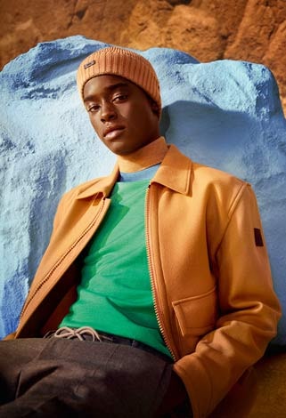 Orange jacket and hat paired with a green top, for Hugo Boss's autumn campaign.